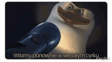 a penguin from madagascar is holding a microphone and smiling at the camera .