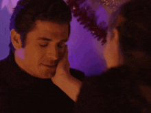 a man kissing a woman 's hand in front of a purple background