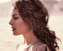 a close up of a woman 's face with a crown on her head