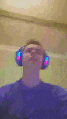 a man wearing a pair of headphones looks up at the sky