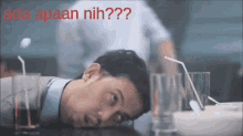 a man laying on a table with the words ada apaan nih on the top