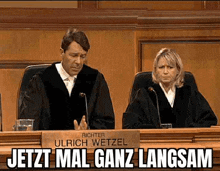 a man and a woman are sitting at a bench in a courtroom .