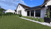a white house with a black roof is surrounded by a lush green lawn