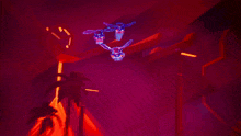 a close up of a purple and red glowing object in the dark .