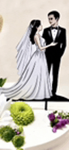 a wedding cake topper of a bride and groom standing next to each other on a white plate .