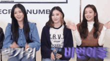three girls are standing in front of a sign that says ecf number