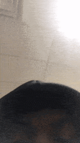 a close up of a person 's face with a white ceiling