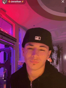 a young man wearing a black hat with the name jonathan on the top