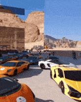 a group of cars are parked in front of a building that says al-ula saudi arabia on it