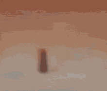a blurred image of a person 's face with a white object in the foreground