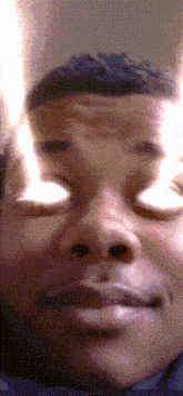 a pixelated image of a man 's face with a blurred background