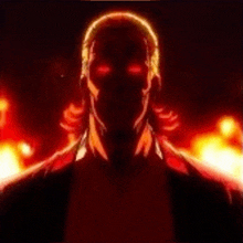 a close up of a man 's face with red eyes in the dark .