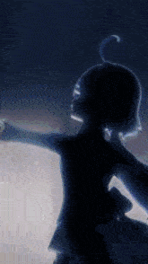a silhouette of a person in a dark room with their arms outstretched