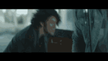 a blurry picture of a man with a beard laughing