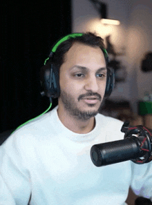 a man wearing headphones and a microphone looks to the side
