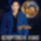 a blurry picture of a man in a blue jacket and a blurred image of a man in a yellow hat
