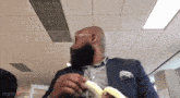 a man in a suit is eating a banana