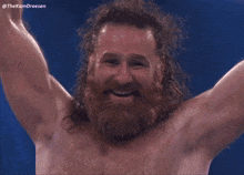 a man with a beard and long hair is smiling with his arms in the air and a caption that says thekamdreesen