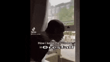 a person is standing in front of a window with the words `` how i keep the rent low in oresfall '' on it .