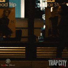 a poster for trap city shows a man walking across the street