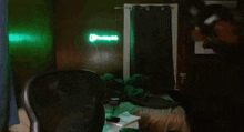 a room with a bed and a neon sign that says dunkin donuts