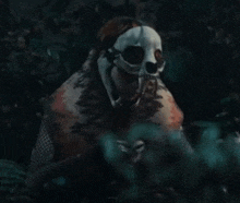 a person wearing a skull mask holding a knife