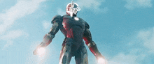 iron man is flying through the air with his arms outstretched and his head is visible .