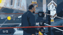 a man in a wrestling ring with a sign that says uk