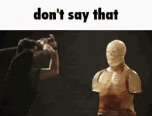 a man is standing next to a statue of a man .