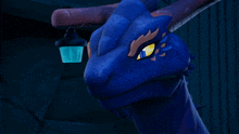 a close up of a blue dragon with yellow eyes
