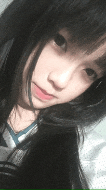 a close up of a girl 's face with black hair