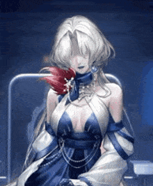 a woman in a blue and white dress is sitting in a chair with a red flower in her hand .