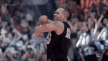 a man is throwing a basketball in front of a crowd .