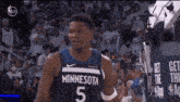 a basketball player wearing a minnesota jersey is standing in front of a crowd