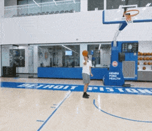 a basketball court with a henry ford health sign on it