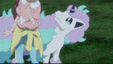 a girl in a pink shirt stands next to a white and purple pokemon