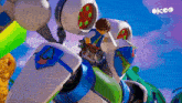 a cartoon character is riding on the back of a robot with the word okeo on the bottom
