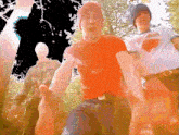 a man in a red shirt is dancing with another man in a superman shirt