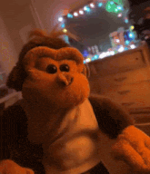 a stuffed monkey is standing in front of a mirror in a room