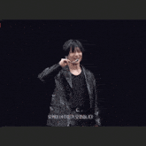 a man with his arms outstretched is wearing a black shirt and a black leather jacket