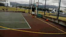 a man is playing soccer on a court with a ball