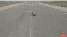 an aerial view of a car on a track with the words thinkjules on the bottom right