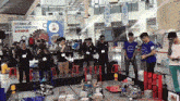 a group of people standing in front of a sign that says 2018 first ftc
