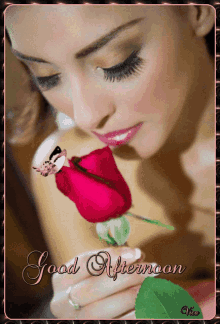 a woman is holding a red rose with the words good afternoon written on it