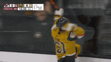 a hockey player in a yellow jersey with the number 21 on it