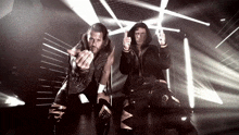 a couple of men standing next to each other with one wearing a jacket that says ' a ' on it