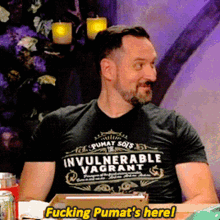 a man wearing an invulnerable vagrant t-shirt says fucking pumat 's here