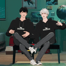 two boys wearing black hoodies that say brave
