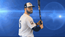 a baseball player holding a bat with the number 16 on his jersey