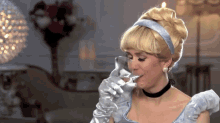 a woman in a cinderella costume drinking from a glass